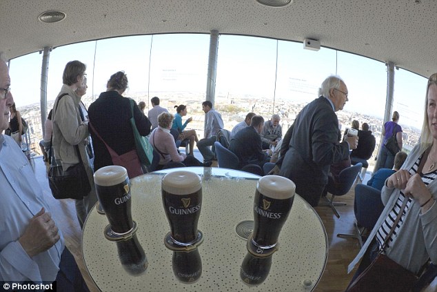 Drink in the view: Tourists admire Dublin from the heady heights of the Guinness bar