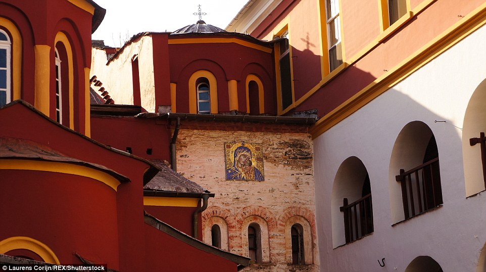 Majestic: A close-up of the decorated red and yellow Vatoupedi church reveals a religious icon on the wall