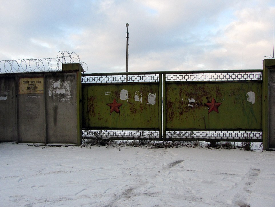 Secretive: These red Soviet stars appear battered and worn but they mark the gate to a military base where the Russians are said to be constructing a new missile base where weapons will have a range of 310 miles and could reach Berlin