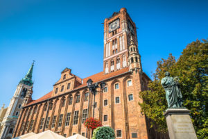 Town hall and Copernicus monument in Torun old town Poland